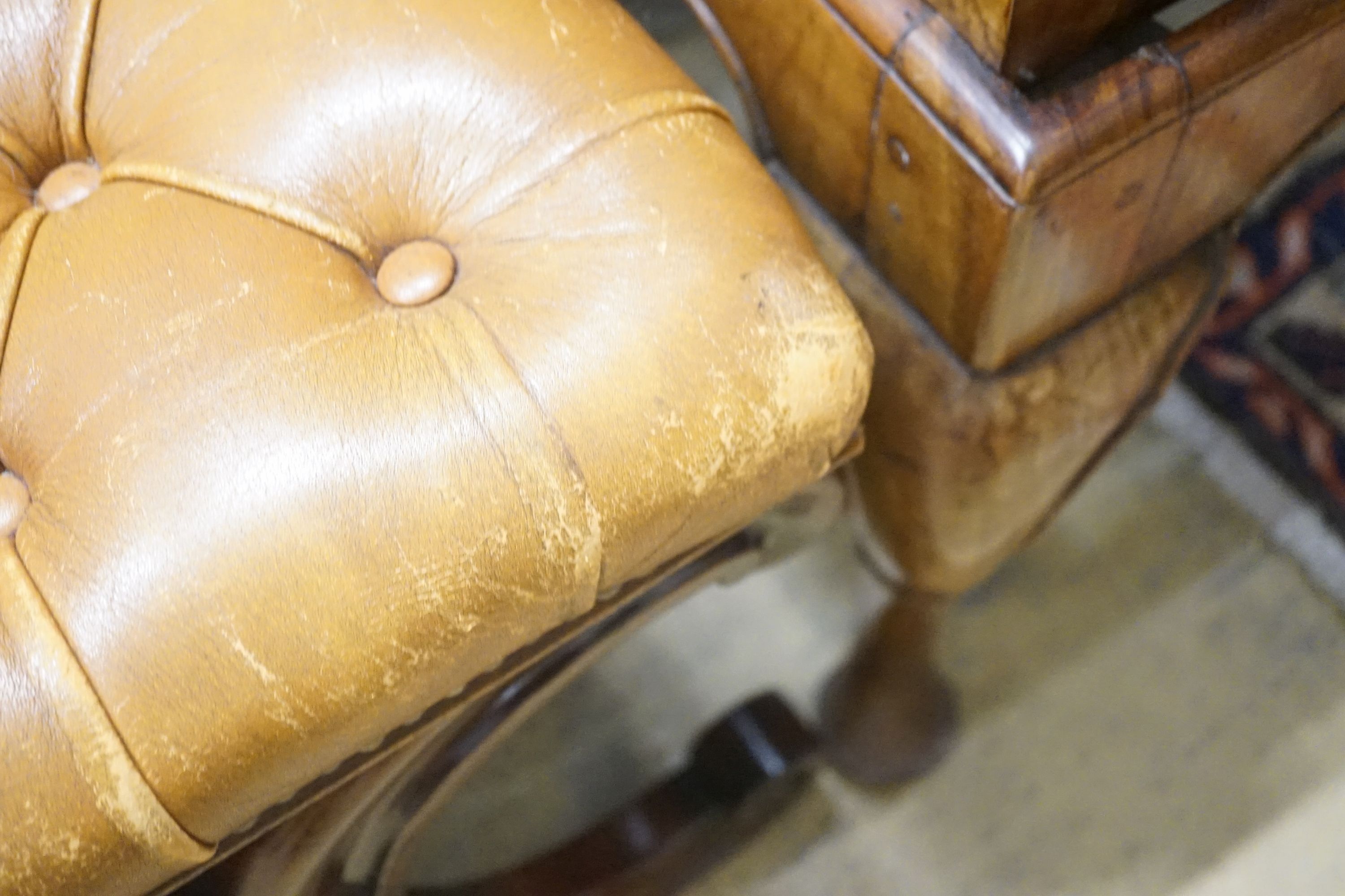 A Victorian carved X-framed rosewood footstool, upholstered in a buttoned brown leather, width 90cm depth 57cm height 42cm